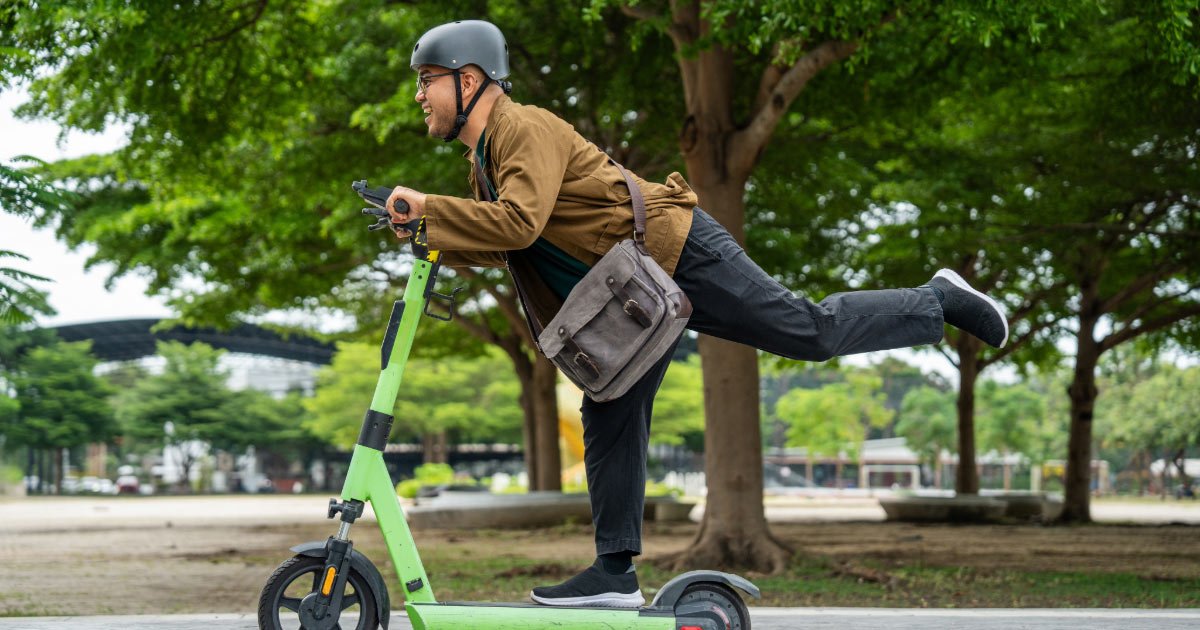Man using e-scooter to get to and from work