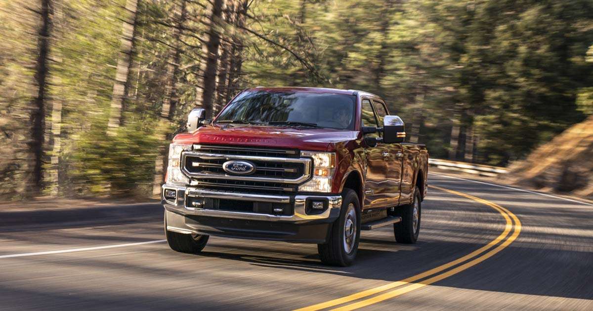 Red F-Series Ford pickup truck driving on mountain roads