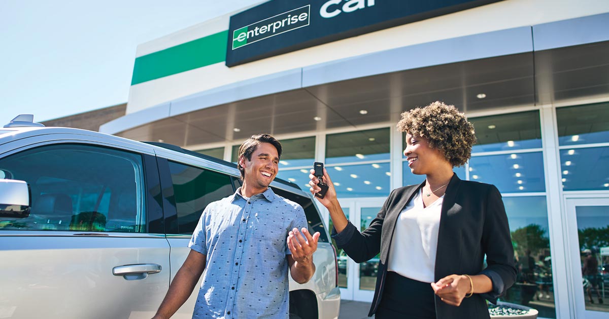Man being handed keys to his rental car from Enterprise employee