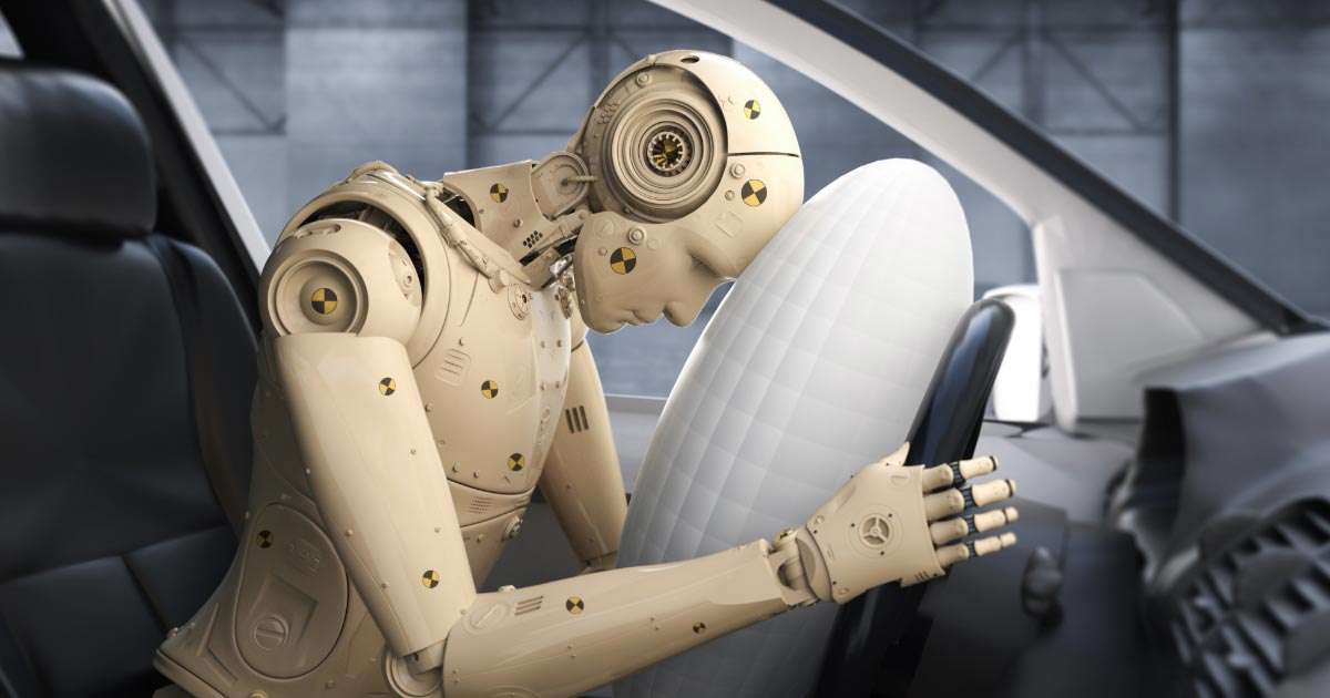 Crash test dummy impacting driver's side airbag at impact