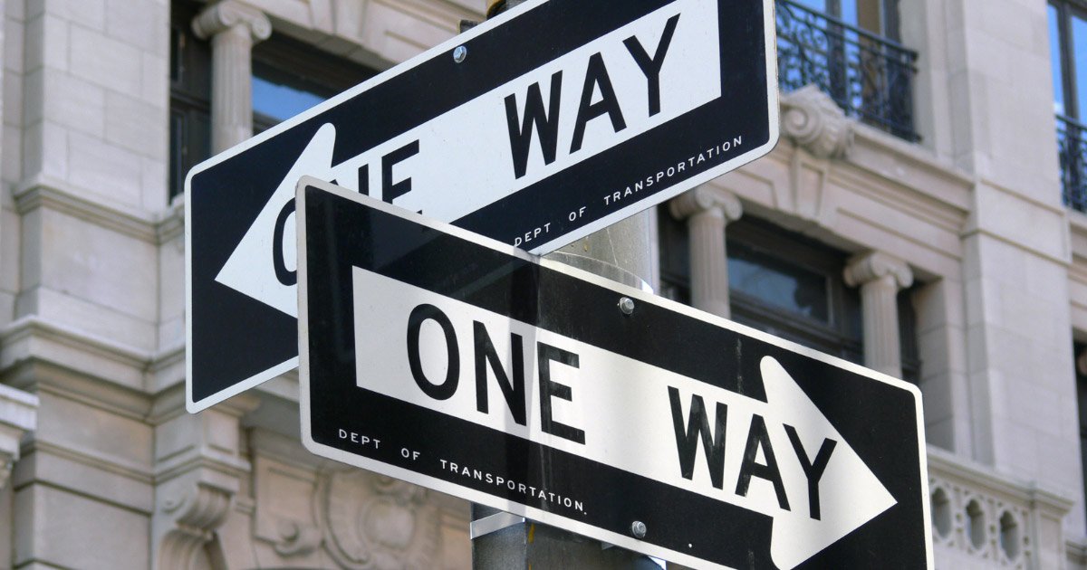 Two One Way signs on street corner in Arlington