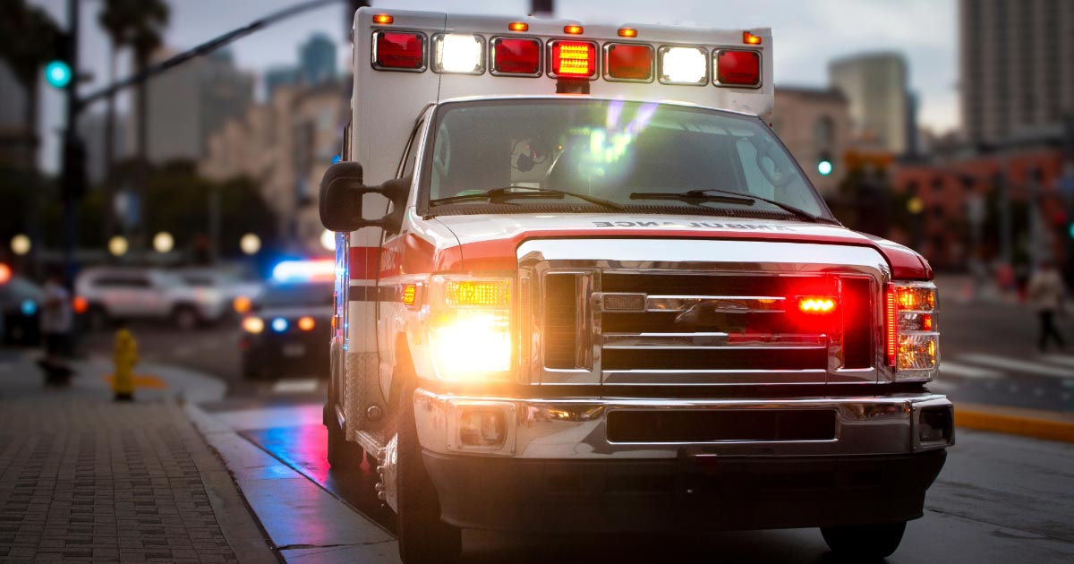 Ambulance with lights on arriving at an accident scene